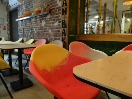 des fauteuils et tables de couleurs dans une boulangerie